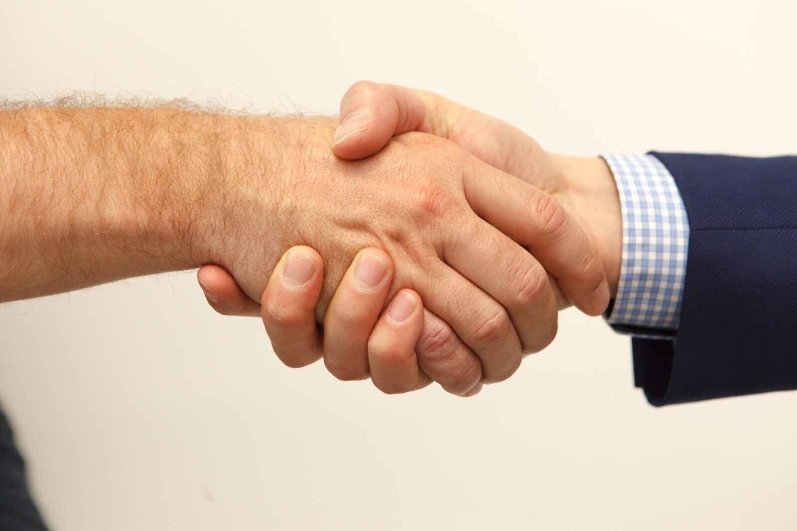 Two people making a business deal by shaking hands