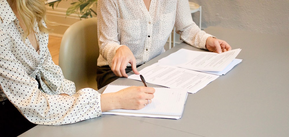 Ownership without Liens - Women signing documents